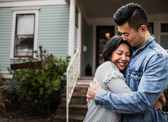 Man and Woman in Front of Foreclosure House