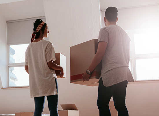 People Move Boxes Out of Damaged Home